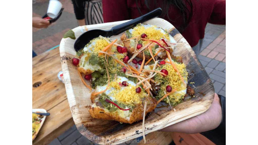 Plate of allo tikki garnished with pomegranate seeds, an iconic Delhi street food
