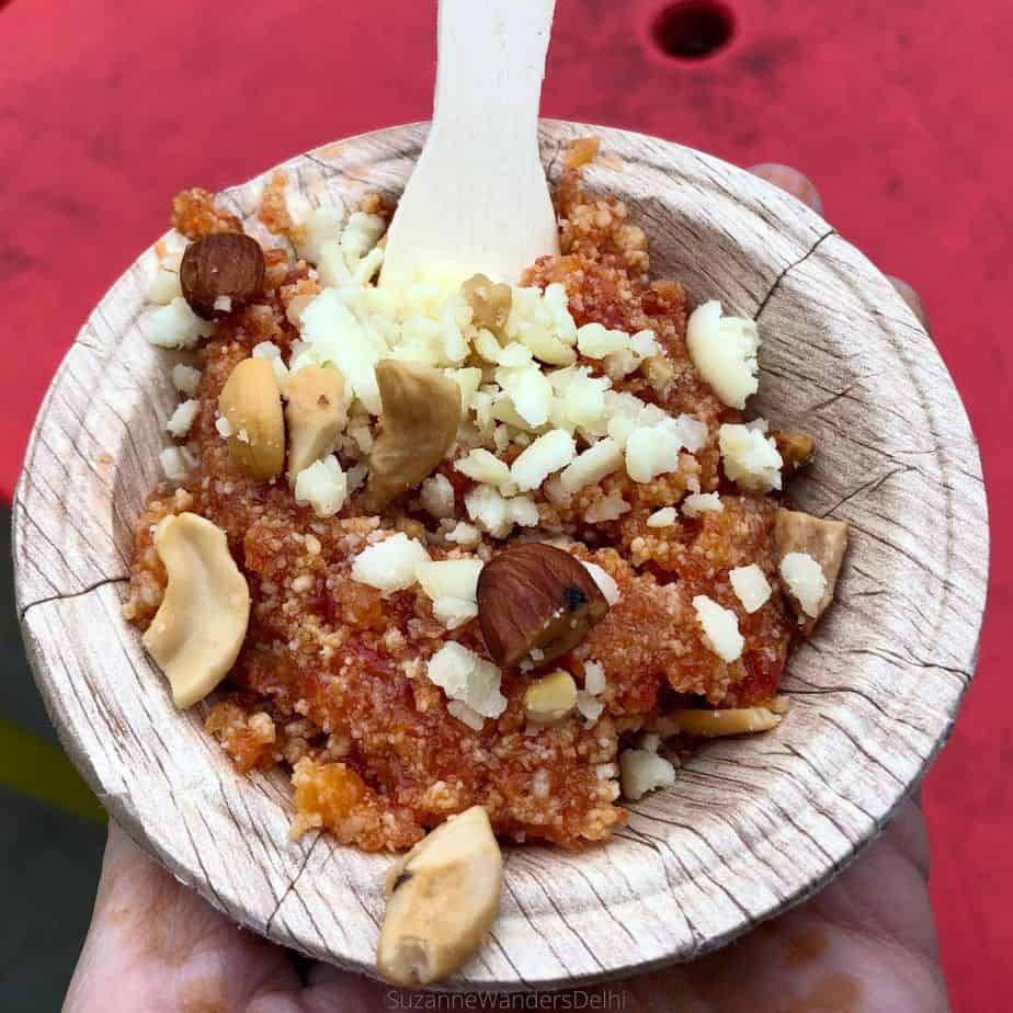 Serving of carrot halva on a red table, a famous winter sweet in Delhi