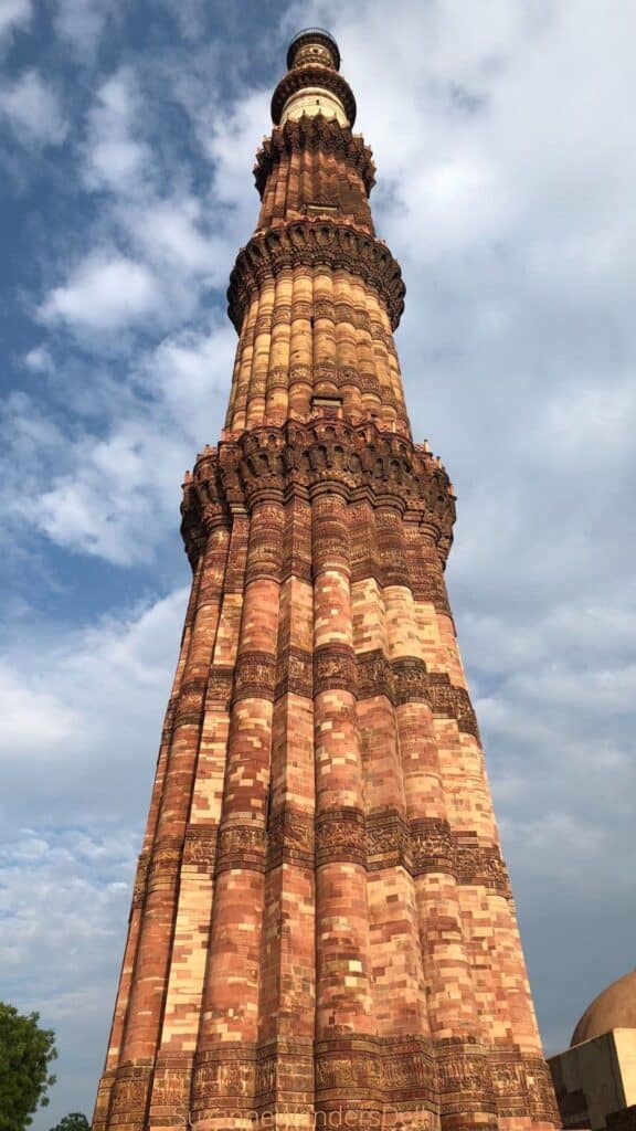 The minar at Qutab Minar with blue sky in background, a must site for a first time visit in Delhi