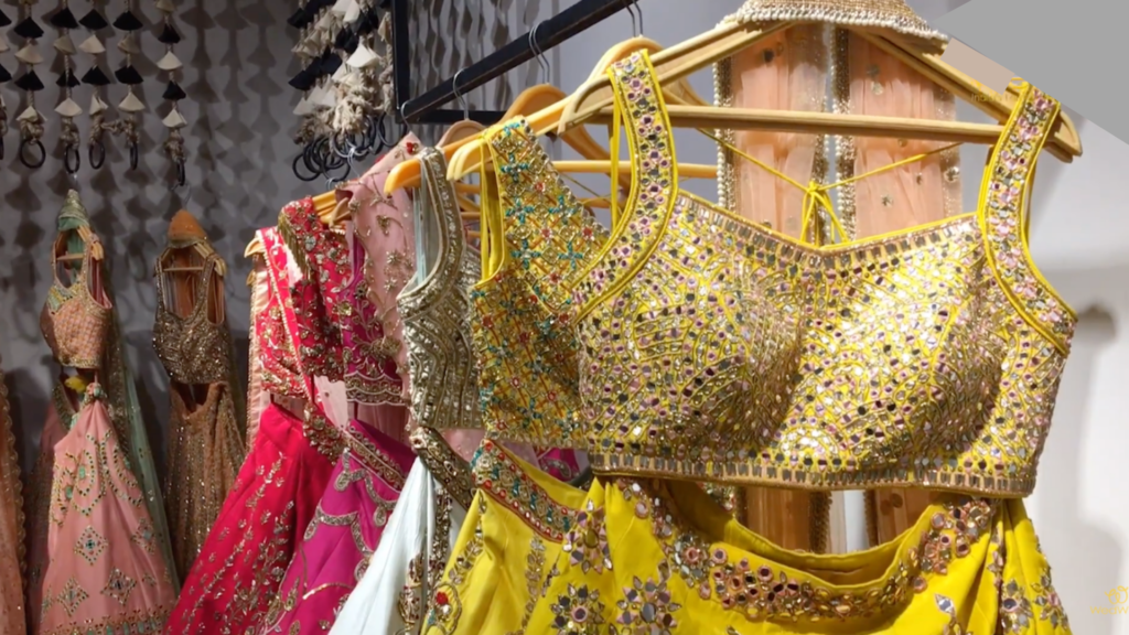 Heavily beaded and embroidered fancy dresses on hangers in boutique