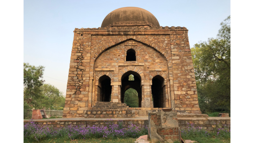 Front view of Barah Khamba with purple flowers in foreground