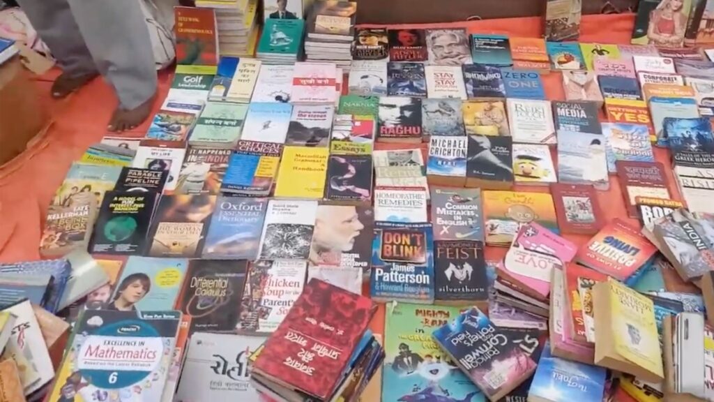 Display of books laid out on floor at Sunday Book Market, one of the cheapest book markets in Delhi