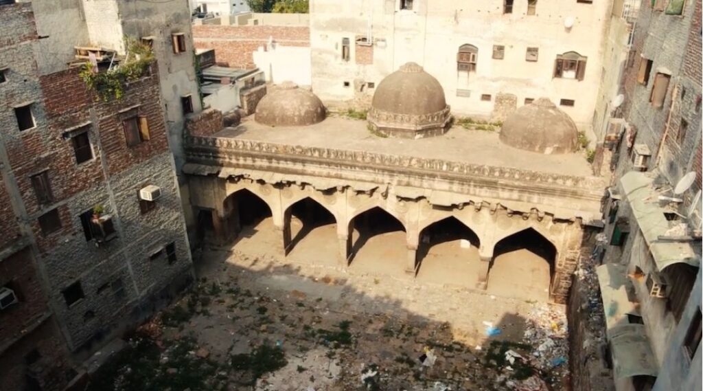 Elevated view of mosque hemmed in by construction/35 Best off the Beaten Path Sites in Delhi
