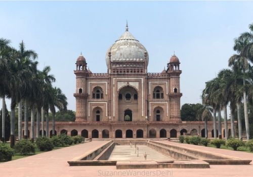 Full view of Safdarjung tomb with fountain in middle and flanked by palm trees on both sides