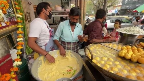 two men cooking at Ram Laddu Food Corner at Central Lajpat Nagar Market, one of the best markets for street food that isn't in Old Delhi