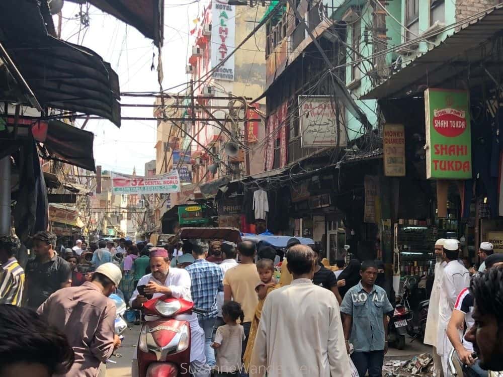 A congested street in Old Delhi full of pedestrians and mopeds