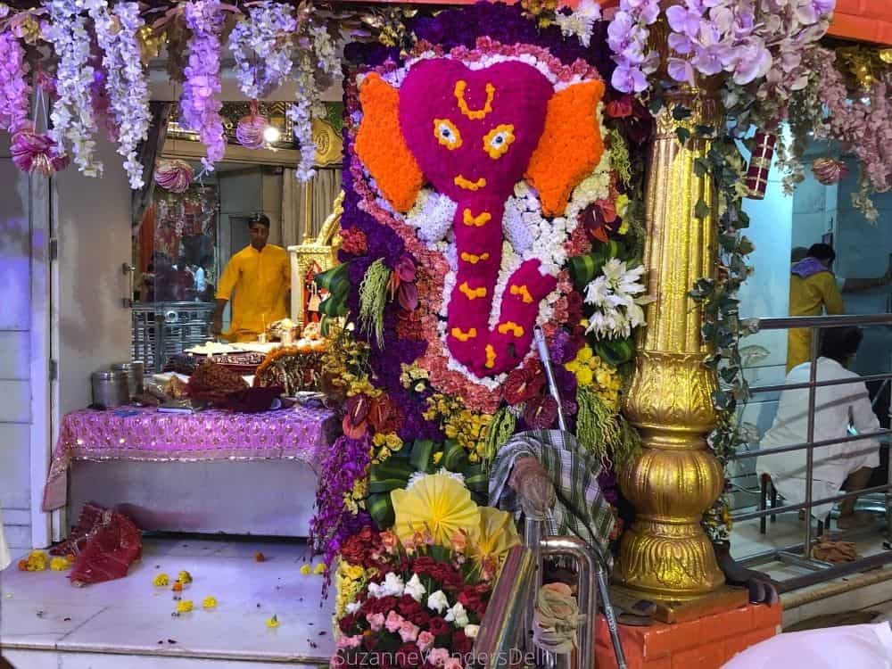 An image of Lord Ganesha made entirely of flowers inside Jhandewalan Mandir 
