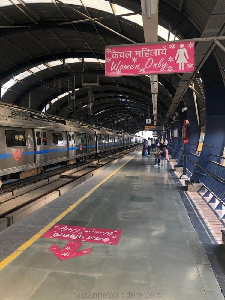 Floor and ceiling signage for the ladies only carriage on the metro platform