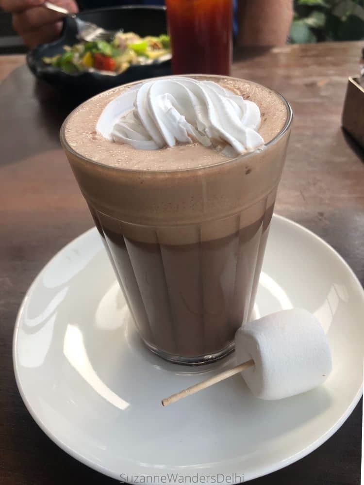 Nutella hot chocolate with whipped cream and a marshmallow on the side