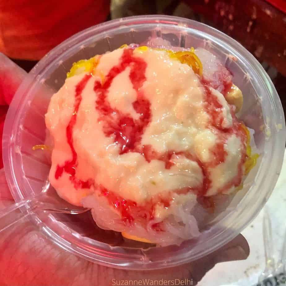 A plate of rabri faluda drizzled with rose syrup, one of the most famous summer Delhi street foods