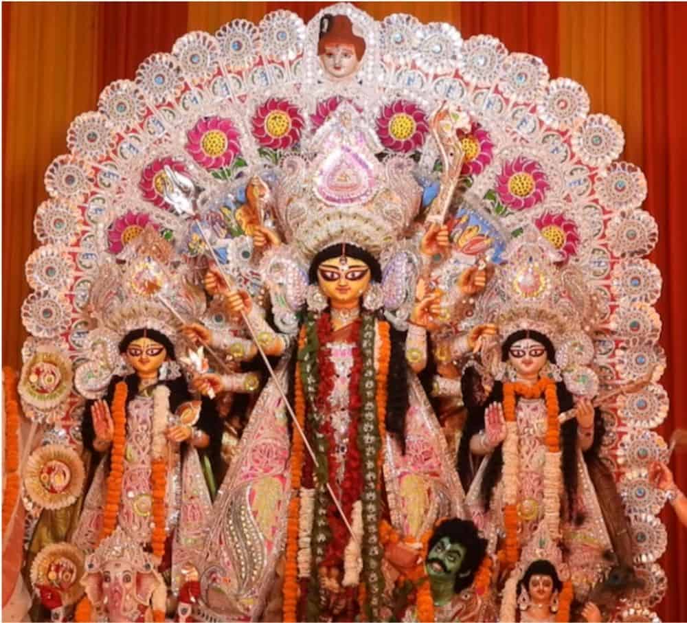 Image of Durga elaborately dressed and garlanded in flowers in the Kali Mandir (CR Park)