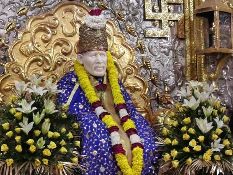 Marble idol of Sai Baba draped  in a massive marigold garland in the Sai Baba Temple on Lodhi Road