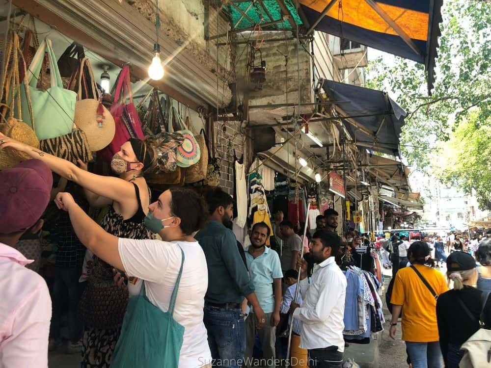 Purse shop and women looking at purses in Sarojini Nagar Market, one of the cheapest markets in Delhi