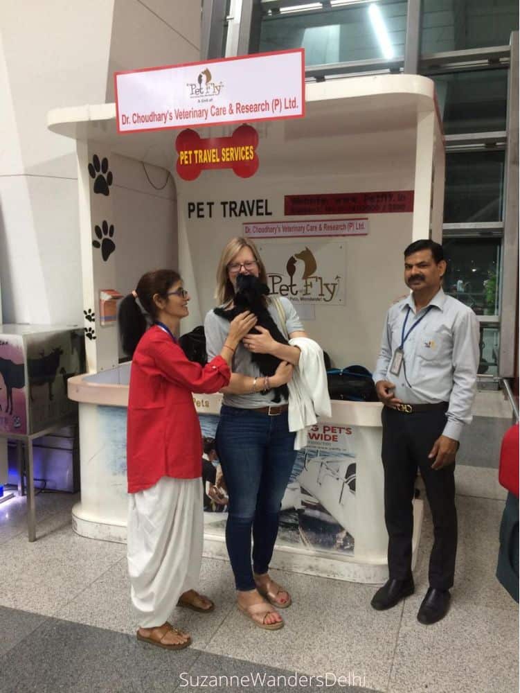 Me holding Watson and Dr. Choudhary and an employee all standing in front of the PetFly booth at the airport / Where to Go in Delhi With Your Dog - The Ultimate Guide
