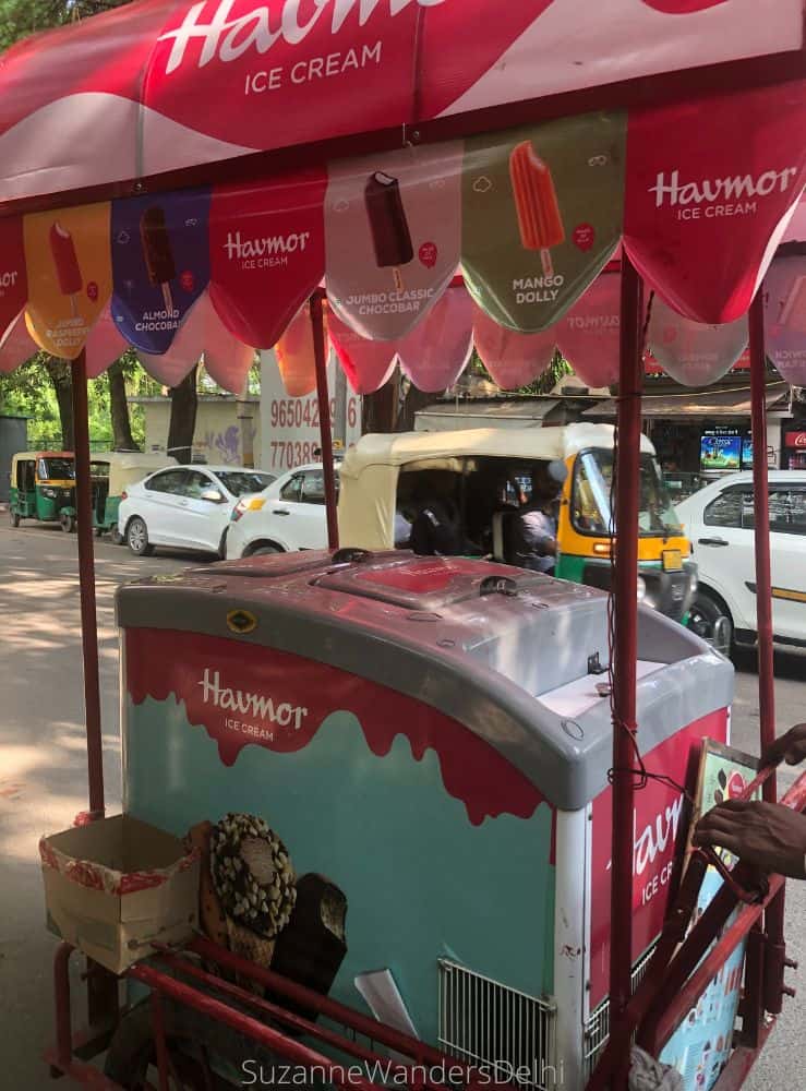 A blue and red Havmor ice cream cart on a city street - Havmor is the best place for ice cream in Delhi
