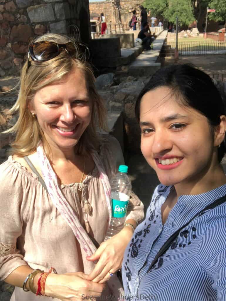 The author and a friend standing outside on a sunny day 