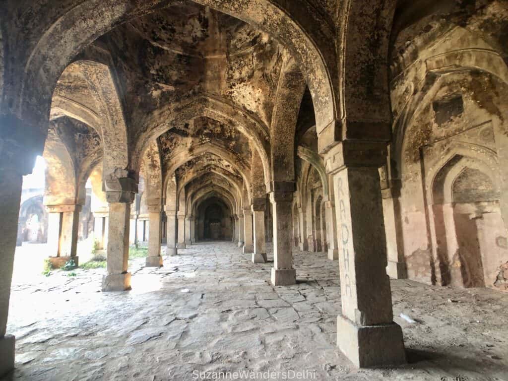 Inside the Begampur Mosque, view of interior arches and columns
