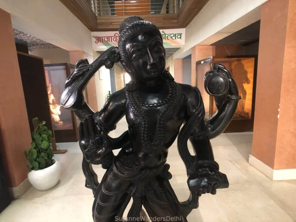 Bonze statue of goddess with many arms in hallway of the former Janpath Hotel, now the IGNCA