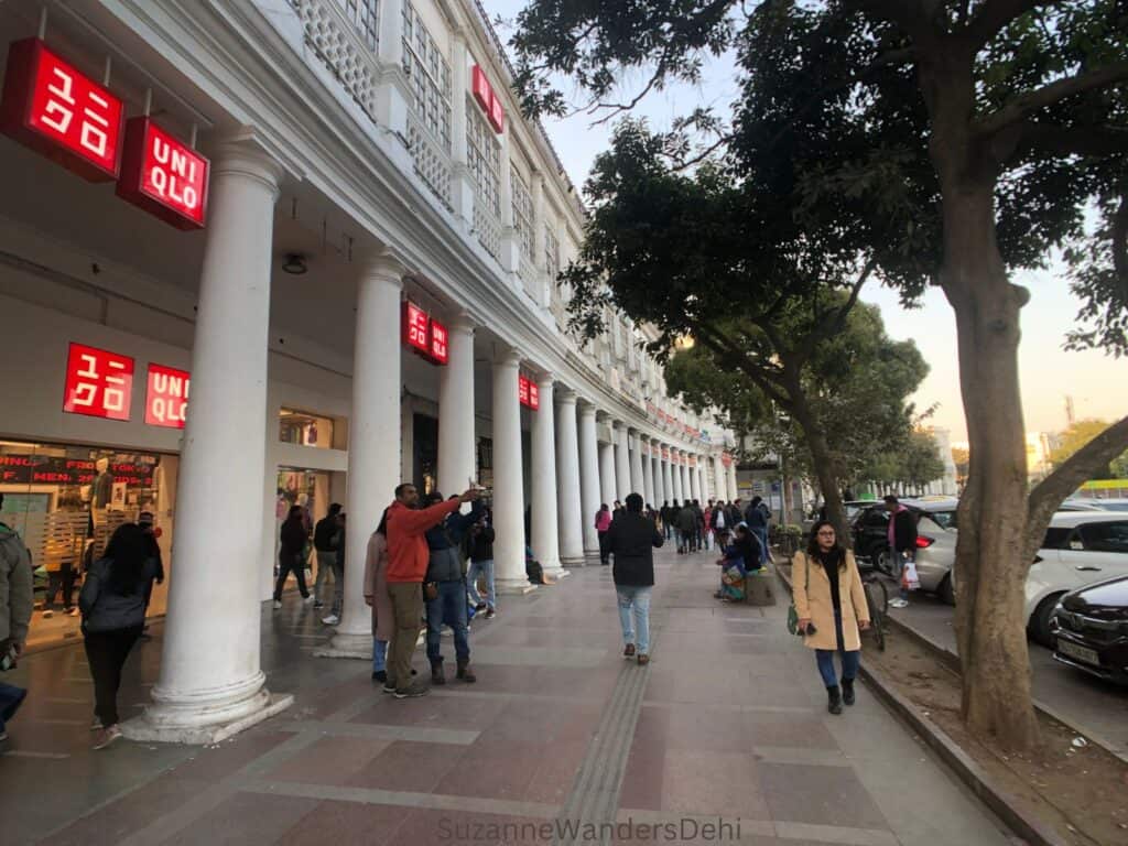 Connaught Place inner circle, Delhi with people walking around in winter coats, a good place to bring kids for shopping with a day in Delhi