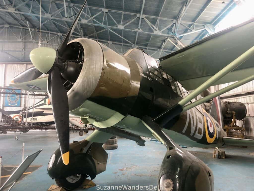 Fighter plane in camouflage colours on display inside an aviation hangar at Indian Air Force Museum, one of the best museums and galleries in Delhi for families