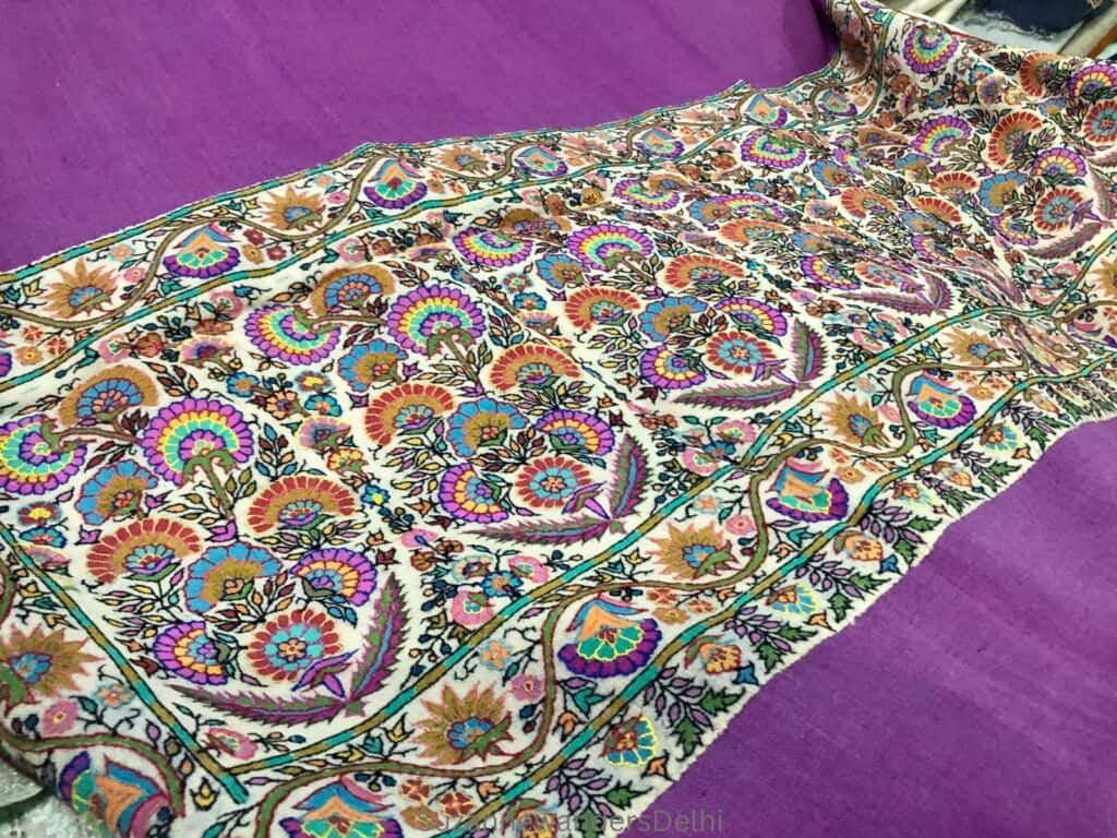 A purple pashmina with heavy embroidered border