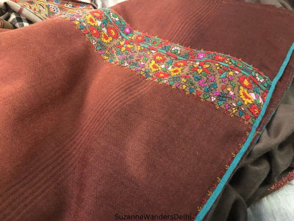 a light brown wool shawl with antique border - it has a diamond pattern, a sign of a fake on how to buy a pashmina