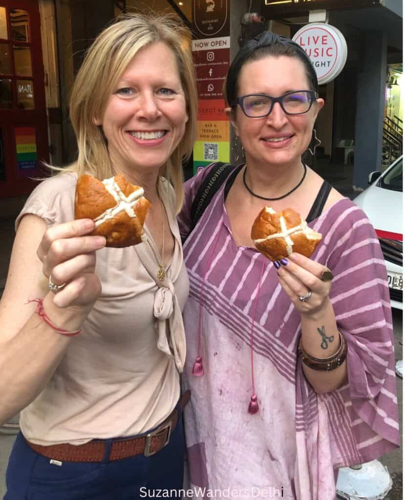 The author and her friend outside of Defence Bakery holding hot cross buns