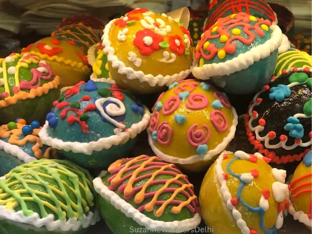 A colourful display of cake Easter eggs, all decorated in colourful icing, at Maxim's