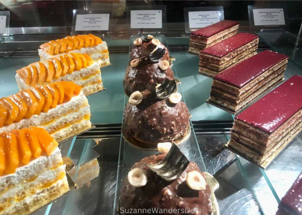 3 rows of French pastry in the glass displat at the Oberoi Patisserie & Delicatessen, one of the best hotel bakeries in Delhi