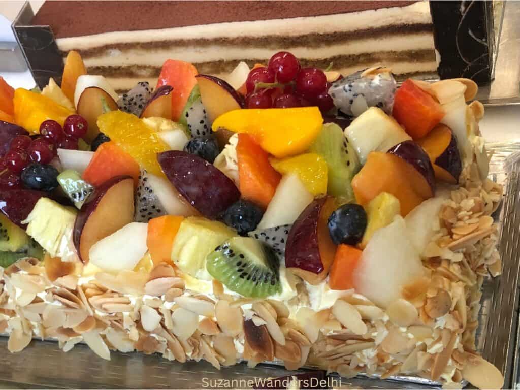 House specialty cake  covered in fresh fruit and almonds at Sidewalk, the best of the hotel bakeries in Delhi