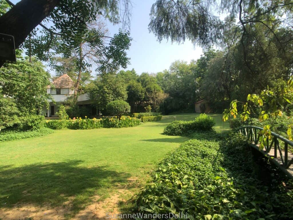 The beautiful green grounds with bridge and trees of Isha Yoga Centre, New Delhi, one of the best ashrams in Delhi
