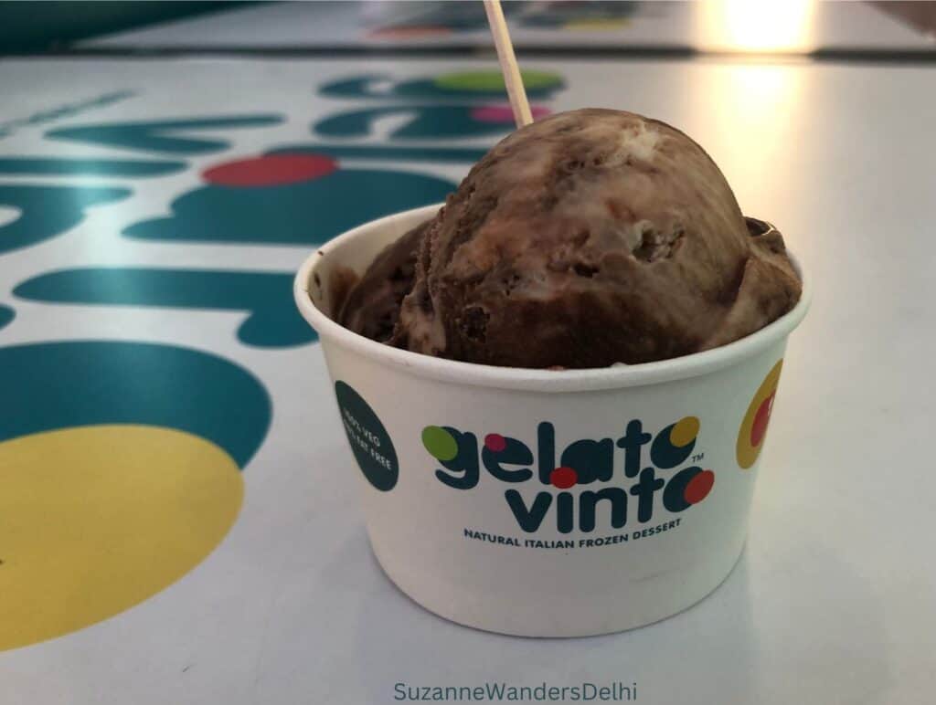 A cup of hazelnut chocolate ice cream on a white counter at Gelato Vinto / one of the best ice cream places in Delhi