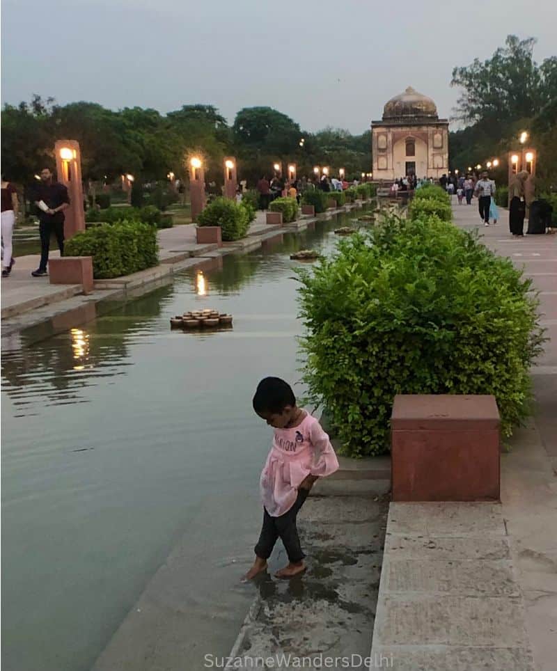 the central vista of Sunder Nursery, a favourite picnic spot in Delhi, with fountain and child dipping foot in