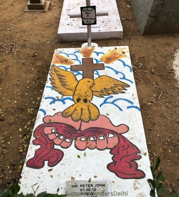 painted white grave with dove at Delhi Cantonment Christian Cemetery