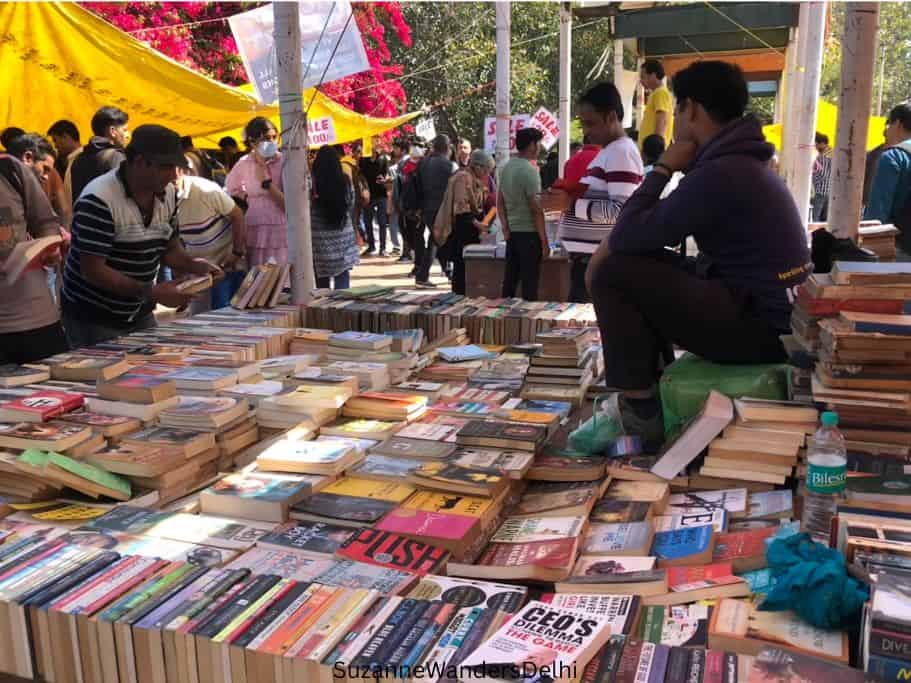 vendor sitting among piles of books at Daryaganj Sunday Book Market in Delhi