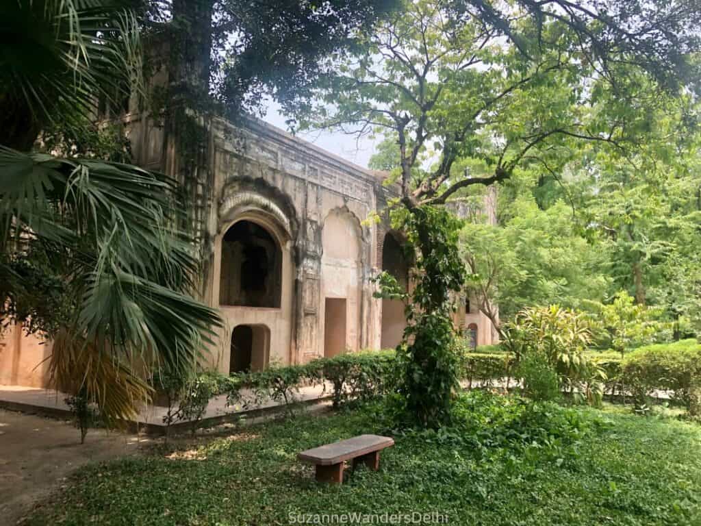 Side view of overgrown Hath Darwaza with stone bench in front at Qudsia Bagh, one of the quietest picnic spots in Delhi