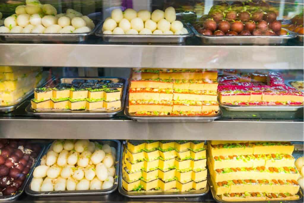 A large display of traditional sweets, including ladoo, barfi and gulab jamun in a Delhi sweet shop during Diwali