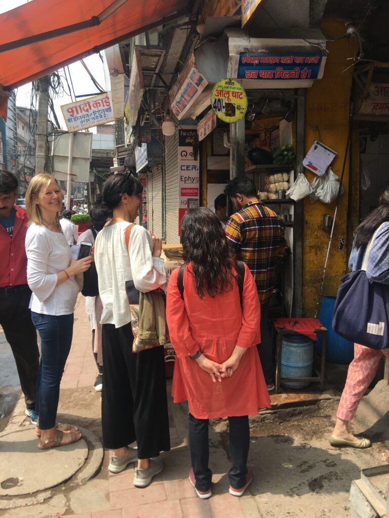 Group of women and the author standing in front of Hira Lal Chaat Corner, one of the best places on an Old Delhi street food tour