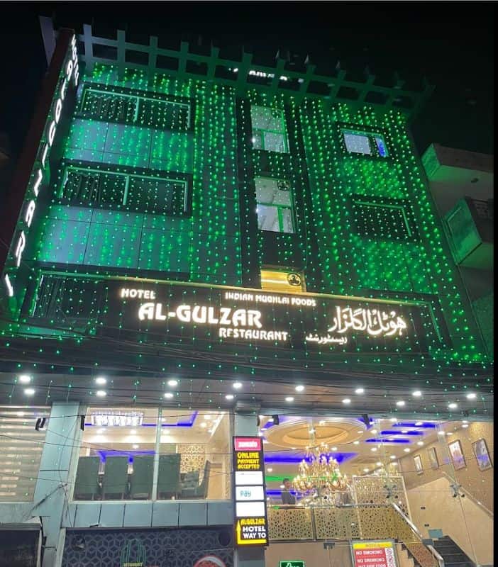 Th exterior of Al-Gulzar restaurant with green diwali lights draped down the front