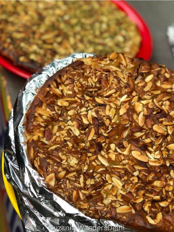 a stack of nut encrusted sheermal partially wrapped in foil at Haji Nadeem Shahi Sheermal, one of the best places to eat in Old Delhi