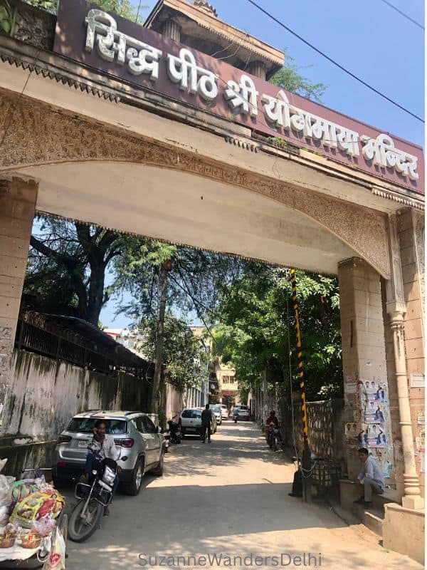 entrance to the lane where Yogmaya is located on a blue sky day in Delhi