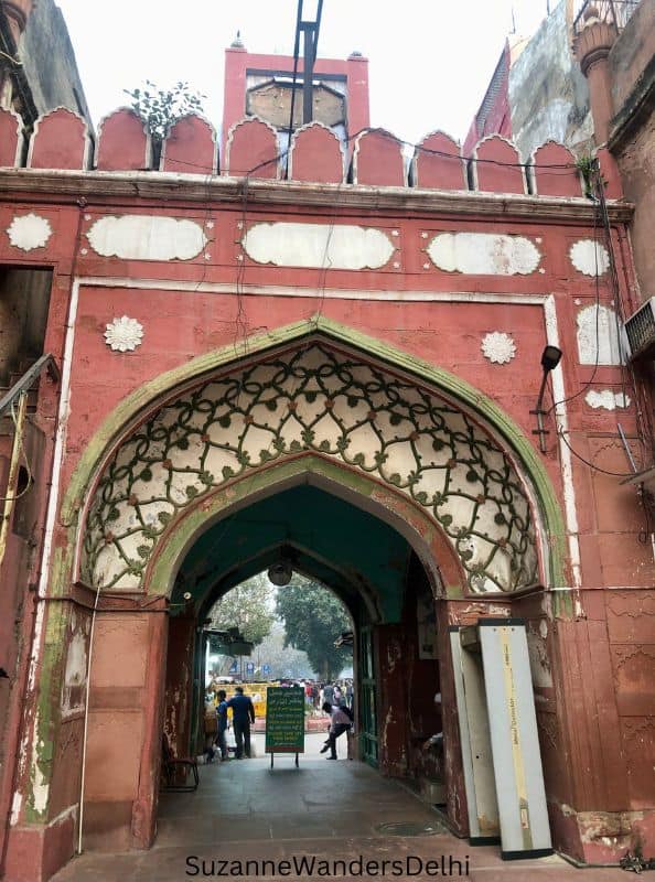 Red sandstone arched gate of Fatehpuri Masjid in Old Delhi, one of the best things to do in Old Delhi