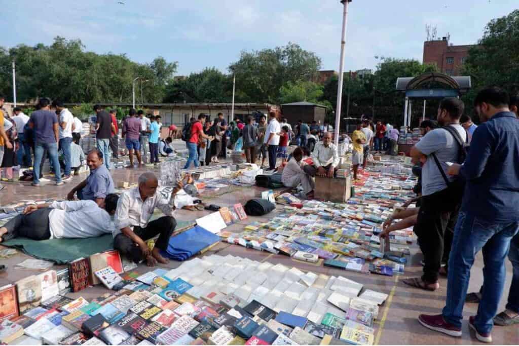 Books set up on the ground, vendors and buyers milling about the Daryaganj Sunday Book Market, one of the top things to to in Old Delhi