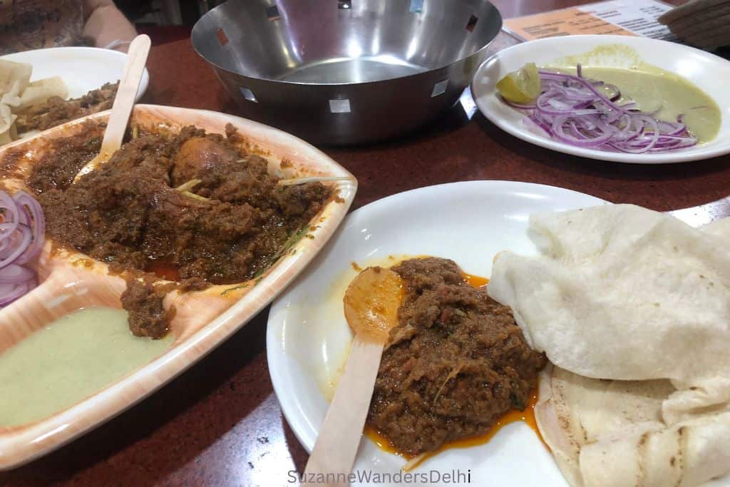 plates and trays of Changezi chicken with rotis at Changezi Chicken in Old Delhi