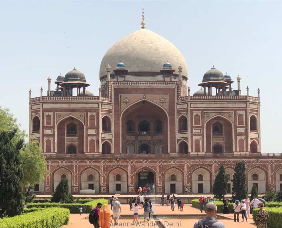 Full front view of Humayun's Tomb with blue sky, typical of architecture of Delhi vs New Delhi
