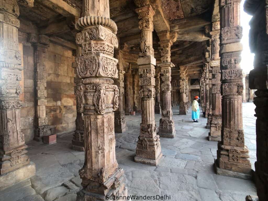 rows of carved pillars in the Quwaat-ul-Islam mosque in Qutub Complex, one of the top places to visit in Delhi