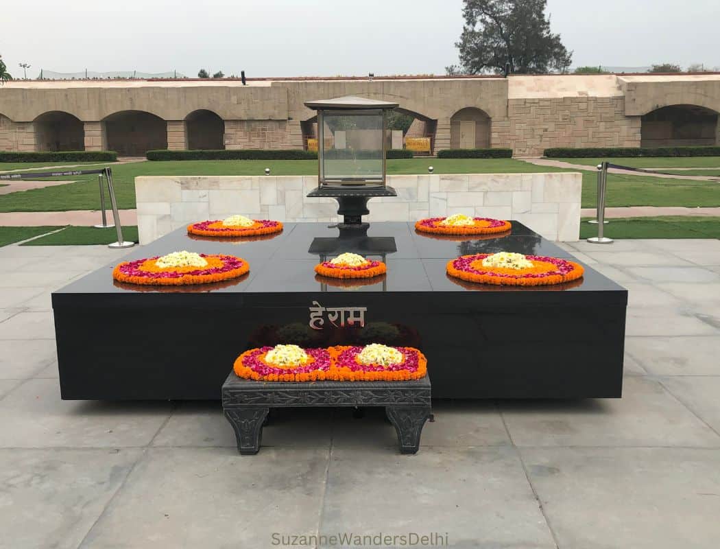 The memorial of black marble adorned in flowers at Raj Ghat