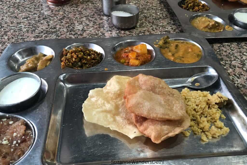 a metal thali tray with food in Delhi at Andhra Pradesh Bhawan, the famous restaurant
