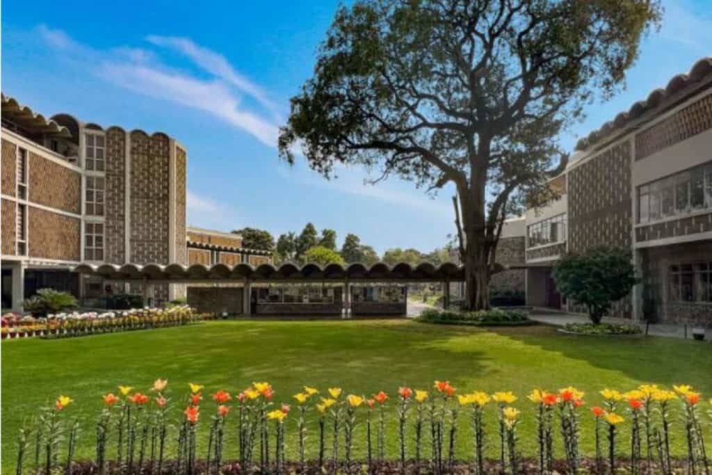 Front view of India International Centre with row of orange and yellow tulips in front