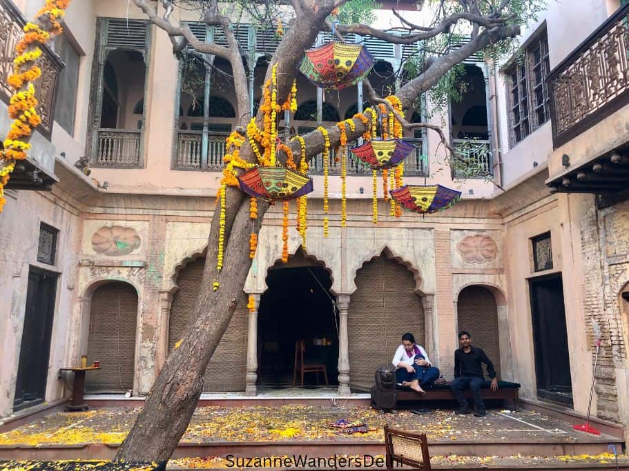 courtyard at Kathika with umbrellas and marigolds hanging from the tree